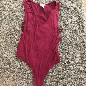 Maroon bodysuit w. cutouts on the sides.